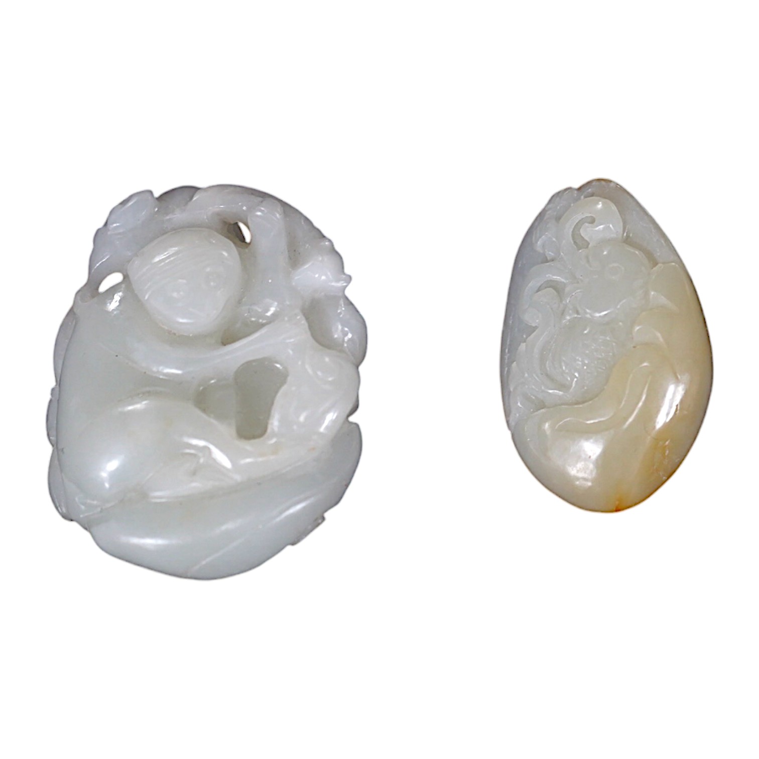 A late 19th / early 20th century Chinese carved jade pendant and a later example, largest 5cm. Condition - good